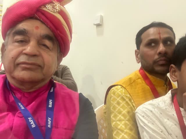 Rakesh Raizada in a turban with fellow guests at a BAPS community event