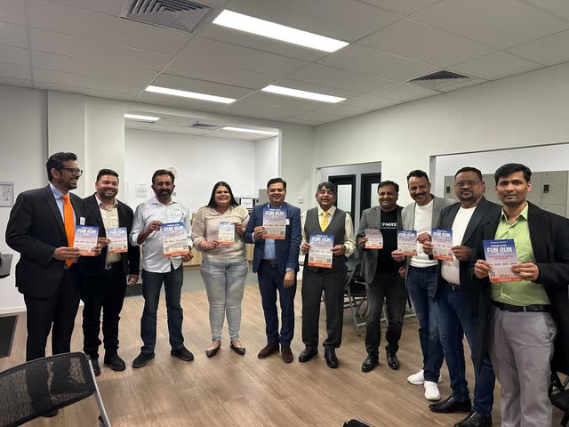 Rakesh Raizada with local community members holding Wyndham Rotary Fun Run and Walk flyers