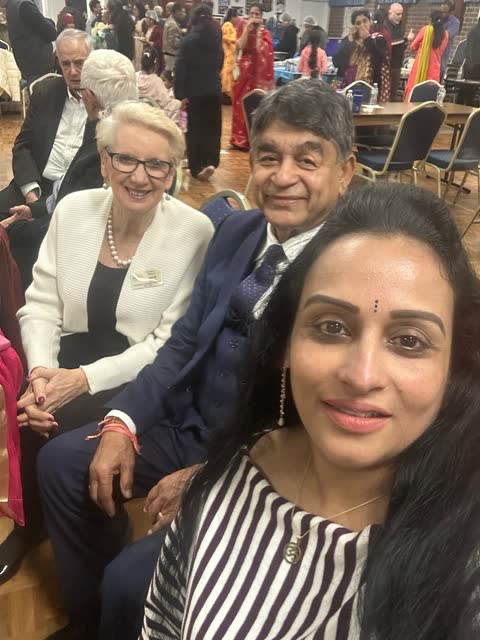 Rakesh Raizada with two community members at a multicultural gathering