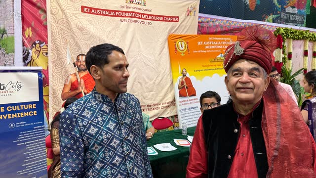 Rakesh Raizada in a turban with a volunteer at the JET Australia Foundation stall