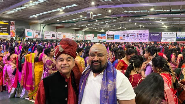 Rakesh Raizada with a friend at a crowded Navratri celebration