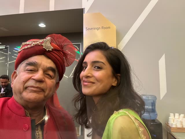 Rakesh Raizada in a turban with a guest at a community function